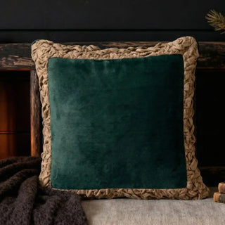 The Jhalak green cushion styled in a moody, dark-toned interior setting for a luxury look.