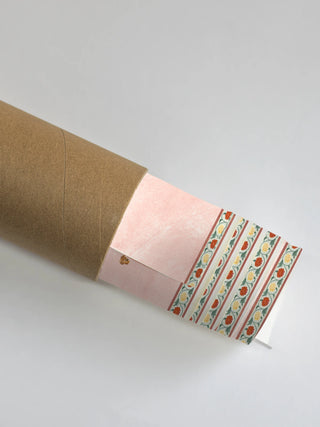 A close-up of the Gulbiya Chinoiserie wall art rolled and packaged in a protective shipping tube, showing the decorative border edge.