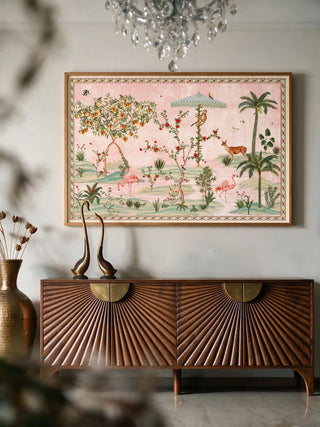 The Gulbiya Chinoiserie wall art in Blush Pink, framed and hung view-entryway above a carved wooden console with brass swan figurines.