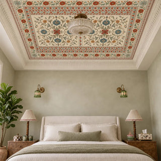 Gulistan Medallion ceiling wallpaper installed on a tray ceiling above a cream-upholstered bed with vintage lamps and brass wall sconces