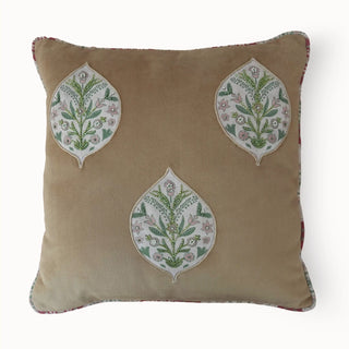 Front view of the square Gulmohar Patra cushion in tan with three hand-beaded leaf patches.