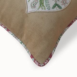 A macro close-up of the Gulmohar Patra cushion highlighting the green beadwork and floral piping.