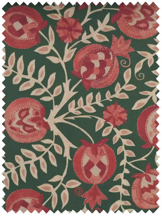 A high-resolution swatch of Gulnaar fabric featuring ruby red pomegranates and ivory leaves on a deep emerald green base.