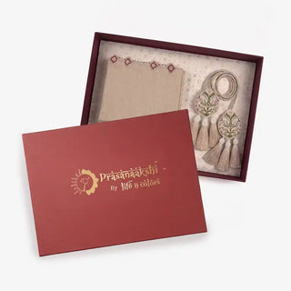 Gulnaz gift set in beige with the maroon Prasanaakshi by Life n Colors lid resting beside the open box holding the runner and corded tassel tiebacks