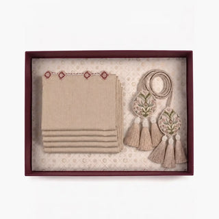 Gulnaz Table Mats & Tieback Gift Set flatlay inside a deep red box showing stacked linen mats and embroidered tiebacks.