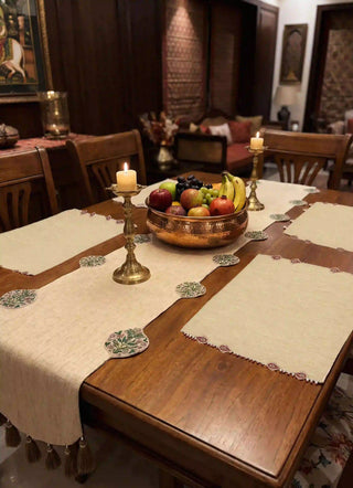 Gulnaz Table Runner styled with brass candlestick holders and a copper fruit bowl on a wooden dining table