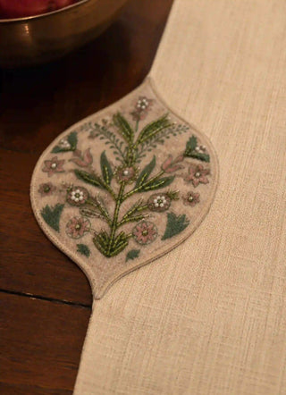 Close-up of the hand-beaded floral embroidery on the scalloped edge of the Gulnaz Table Runner