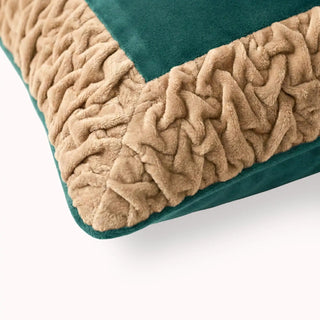 Close-up of the Jhalak cushion showing the intricate texture of the hand-gathered peach ruffles against green velvet.