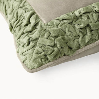 Close-up of the Jhalak cushion showing the intricate texture of the hand-gathered green ruffles against ivory velvet.