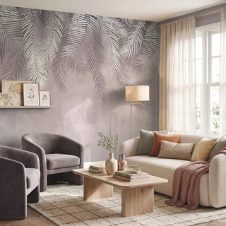 A luxury living room featuring the Hanging Tropical Leaves wallpaper in pink behind a cream sofa and grey velvet armchairs view-livingroom