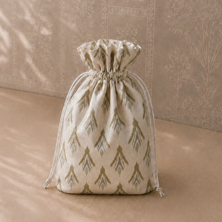 Ikat-print drawstring gift pouch styled alongside the Heer and Ranjha bird tiebacks