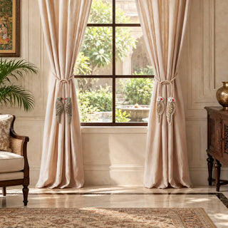 The Heer Ranjha tieback gift set in Sage & Ivory tied back on linen curtains beside a window with a garden view.