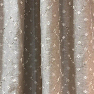Close-up of Heermoti Curtain fabric showing fine embroidery and subtle texture.