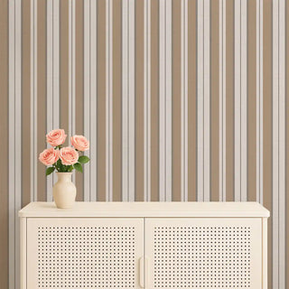 Heritage Beige & Cream Stripe Wallpaper Roll displayed in a living room, complemented by a console table, floral vase, and warm lighting for a cozy setting.