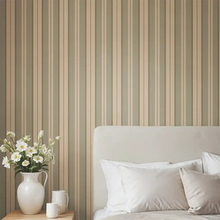 Bedroom styled with Heritage Olive & Beige Stripe Wallpaper Roll, featuring muted olive and beige vertical stripes paired with a cream bed and side lamp.