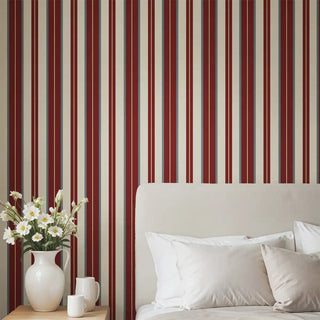 Bedroom interior with Heritage Red & Cream Stripe Wallpaper as a feature wall behind a bed with white bedding.