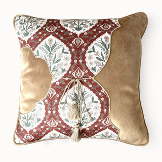 Full studio shot of the Heritage Tie Cushion showing the mixed fabric design and central tassel tie.