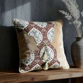 Single Heritage Tie Cushion displayed on a wooden surface in a contemporary room setting.