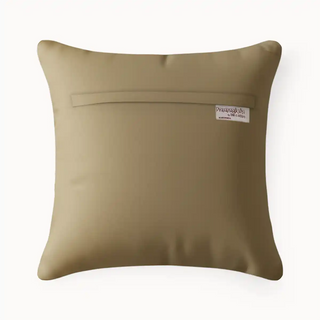 Heritage Tie Beige cushion with a brand label on a white background