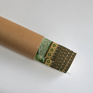 The Hey Olive Fusion wall art print  partially unrolled from its kraft paper shipping tube, showing an abstract marbled texture beside a diamond medallion border and a triangle-stack striped panel in olive, tan and green.