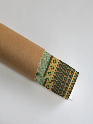 The Hey Olive wall art print partly unrolled from its shipping tube, showing a green marbled panel, a diamond border and triangle stripes in olive and tan.