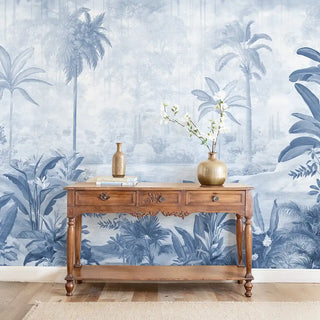 Full wall installation of the Hidden Groove blue and white scenic tropical mural in a living room.