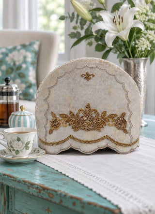 The Hoor tea cosy in Stone, view-vintagetable beside a French press and floral teacup.