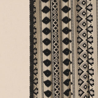 A detailed shot of the Ikkat Fringes curtain fabric, highlighting the intricate hand-woven-inspired geometric and tribal motifs.