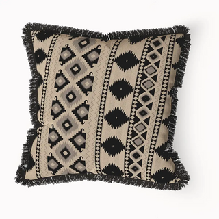 Ikkat Fringes cushion cover featuring a bold, black and beige geometric pattern with vertical stripes and a textured black fringe border.