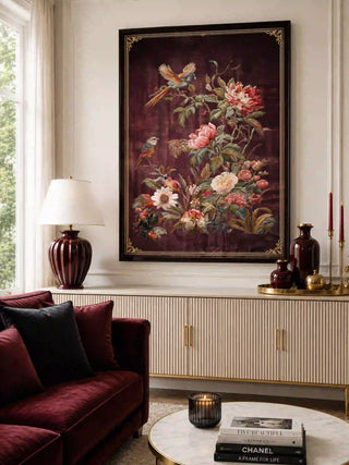 The Imperial Garden wall art in a dark frame above a cream fluted sideboard with burgundy vases, beside a burgundy sofa.