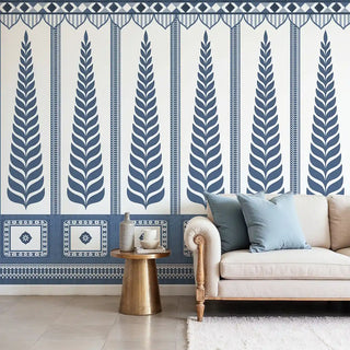 Living room with a decorative wall mural featuring blue leaf patterns on a white background.