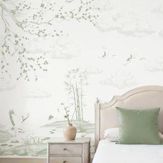 A luxury bedroom featuring the Indigo Whisper sage green mural behind a bed with a matching sage green cushion.