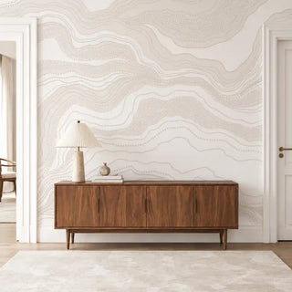 Infinite Flow abstract wallpaper in Ivory Sand behind a wooden console table in an entryway.