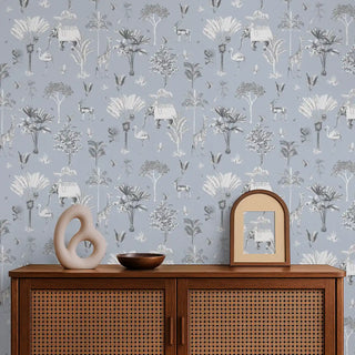 Full wall view of the Itihaas powder blue wallpaper with Indian elephants and animals in a modern room setting.