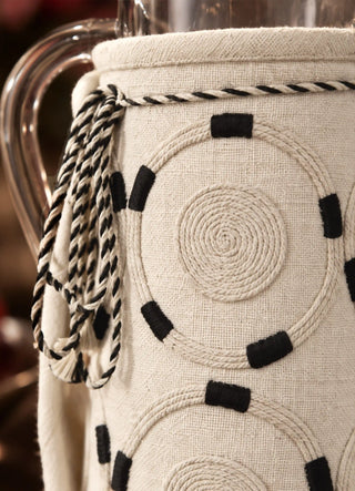 The Ivory Blossoms jug cover in Ivory, view-detail of corded spiral stitching and twisted drawstring tie.