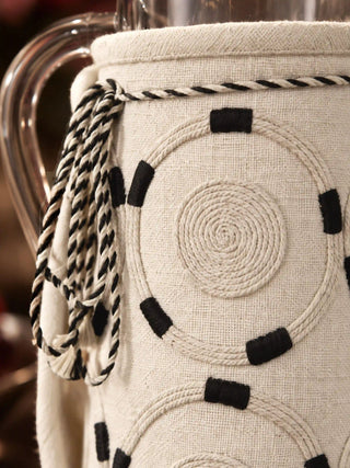 Macro close-up of Ivory Blossoms jug cover showing textured spiral cord embroidery and black thread accents.   