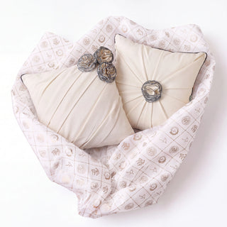 Ivory Gardenia gift set: the Pleated Rosette and Draped Floral cushion covers nestled in Prasanaakshi gift wrap