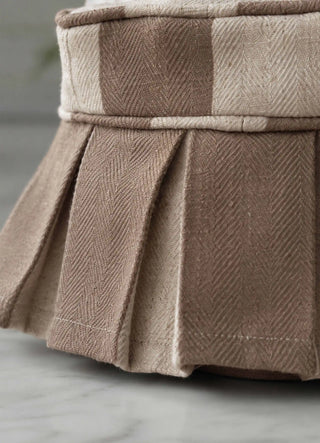 The Izel tissue case in Taupe, view-detail of the pleated skirt and herringbone weave.