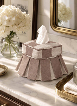 The Izel tissue case in Taupe, view-bathroom beside hydrangeas and a gold-framed mirror.