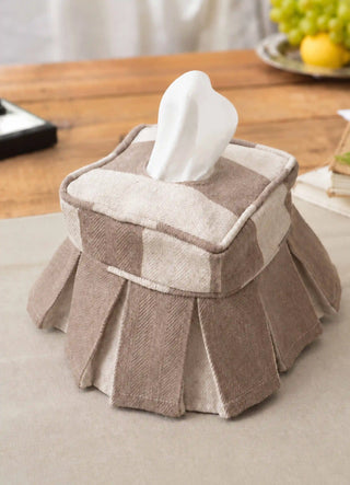 The Izel tissue case in Taupe, view-sidetable beside stacked books and a fruit tray.