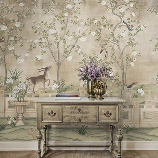 A full-room view of the Jade Blossom Chinoiserie wallpaper mural, showing a delicate scene with blossoming trees and a graceful deer-like animal.