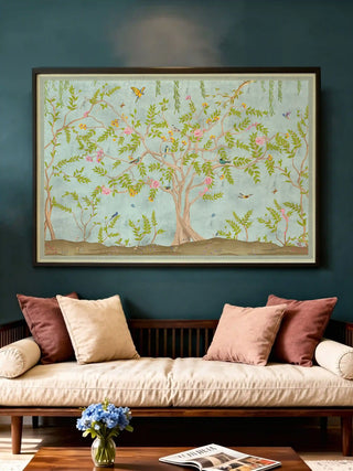 Large Jannat Chinoiserie art print in a dark frame styled above a contemporary daybed with rose-colored pillows.