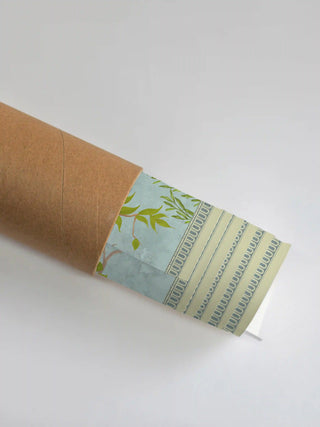 Premium protective shipping tube showing the rolled Jannat Chinoiserie art print with its ornate geometric border.