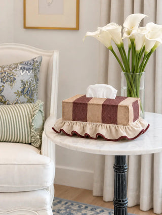 The Juliet tissue case in Wine & Camel, view-sidetable beside calla lilies on a marble table.