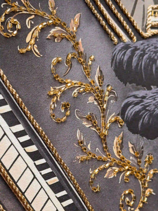 A detailed macro close-up of the Jungle Noir embroidered wall art highlighting gold bugle-bead scrollwork and twisted gold cord on the piano.