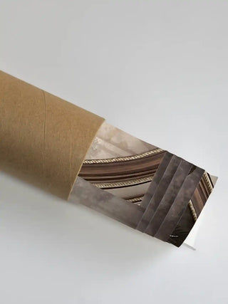 The Jungle Noir wall art partially unrolled from its kraft paper shipping tube, showing arch and rope-trim detailing in brown and stone tones.