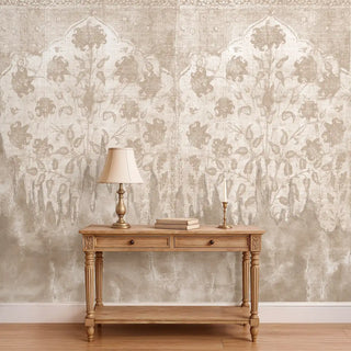 The Kaleen vintage beige floral textile wallpaper styled behind a classic wooden console table with a brass lamp.
