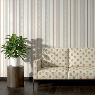 Sofa upholstered in Kalika Fabric against striped wallpaper in soft tones.