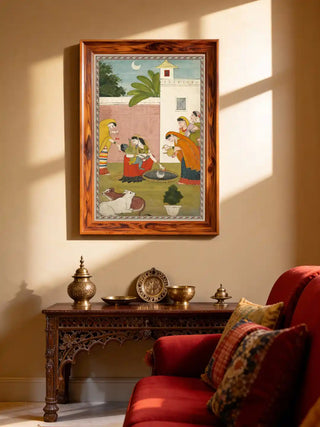 Vintage wall art of child Krishna and Gopis displayed in a modern foyer above a decorative wooden console.