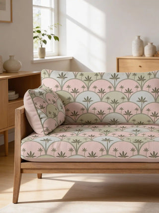 A modern wooden sofa upholstered in Kannan fabric featuring a rhythmic pink and green palm pattern.